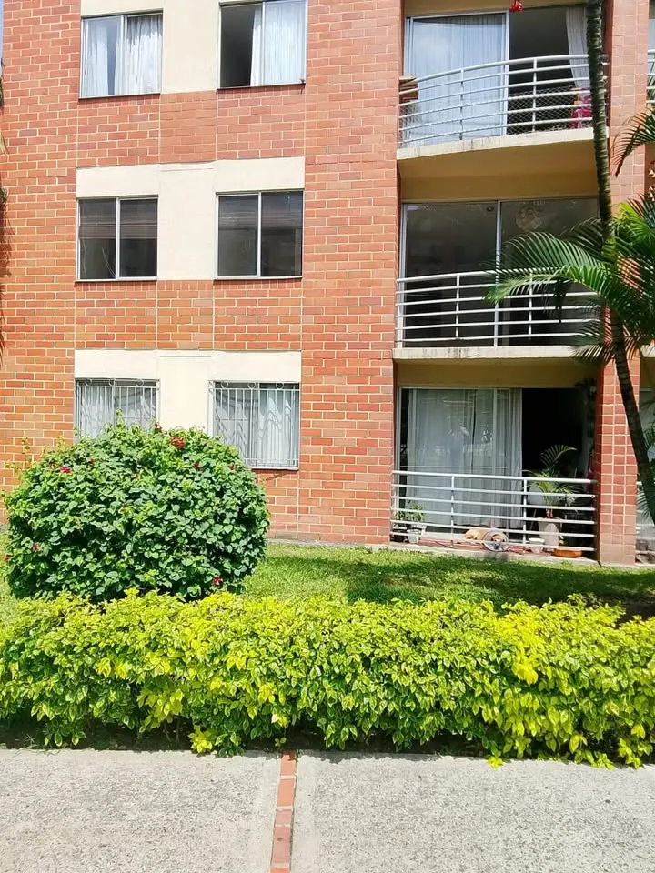 Fachada de ladrillo del conjunto con zonas verdes